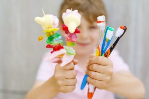 Kid with candy and toothbrush