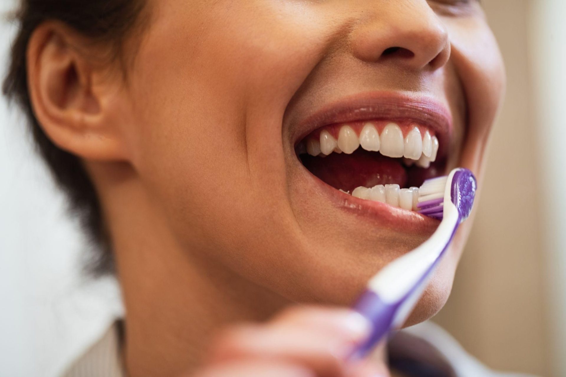 A woman brushing her teeth | Oral Health Niagara Falls